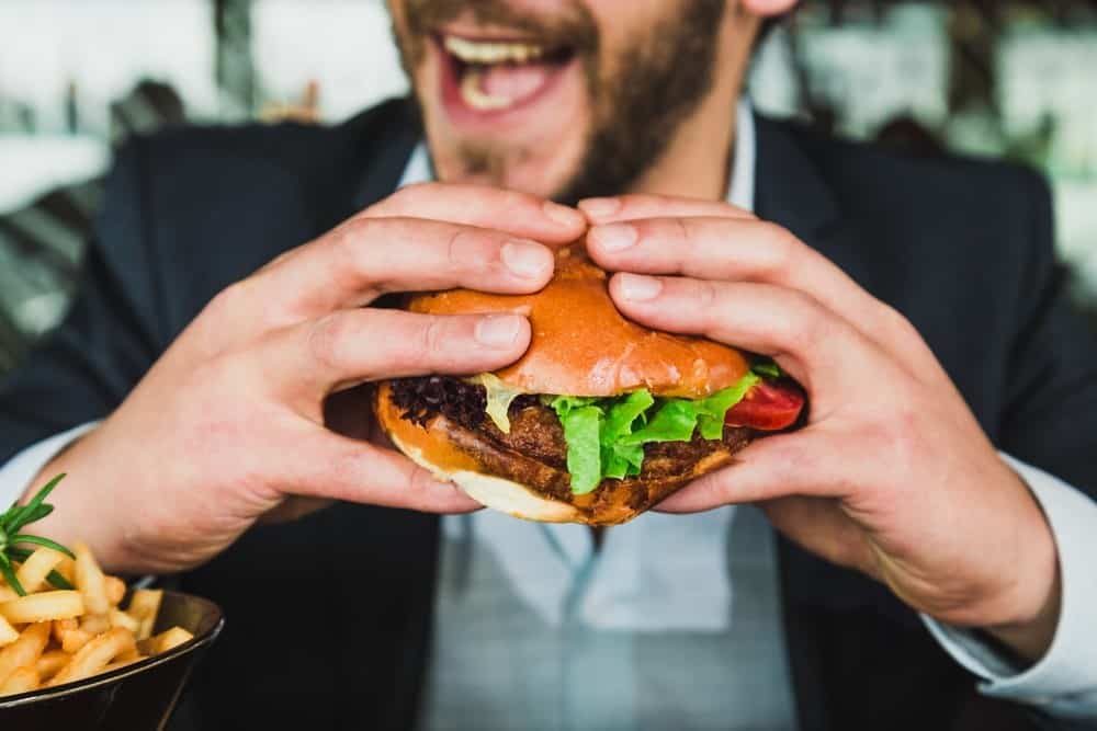 A Man About to Bite into a Burger