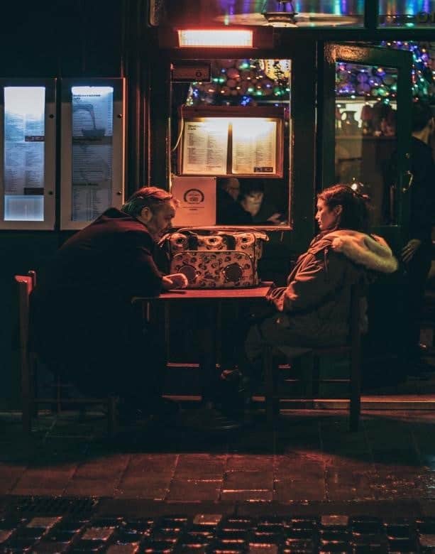 A Couple Sitting at a Restaurant and Having a Conversation