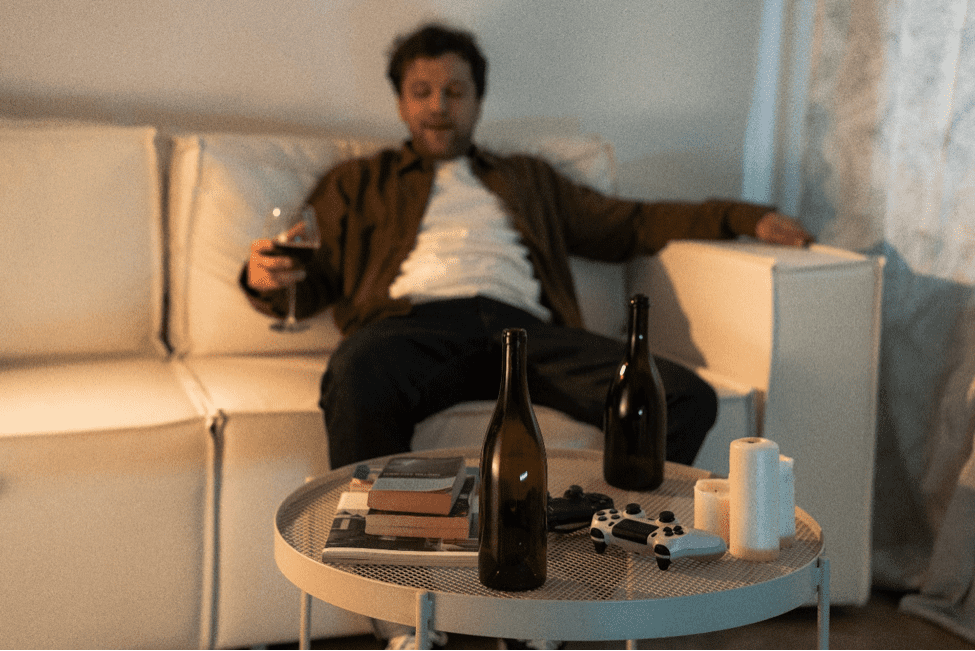 man drinking a glass of wine